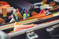 Assorted pens and colored papers in an organizer case